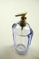 Transparent blue soap dispenser.